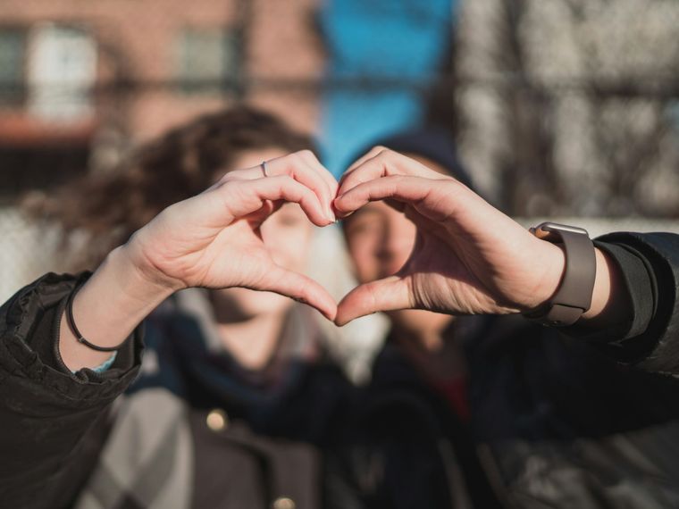 A heart made of four fingers, in the middle of the street, on the way to nowhere.